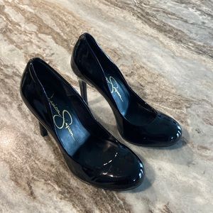 Black patent leather 3.5 inch high heel shoes.